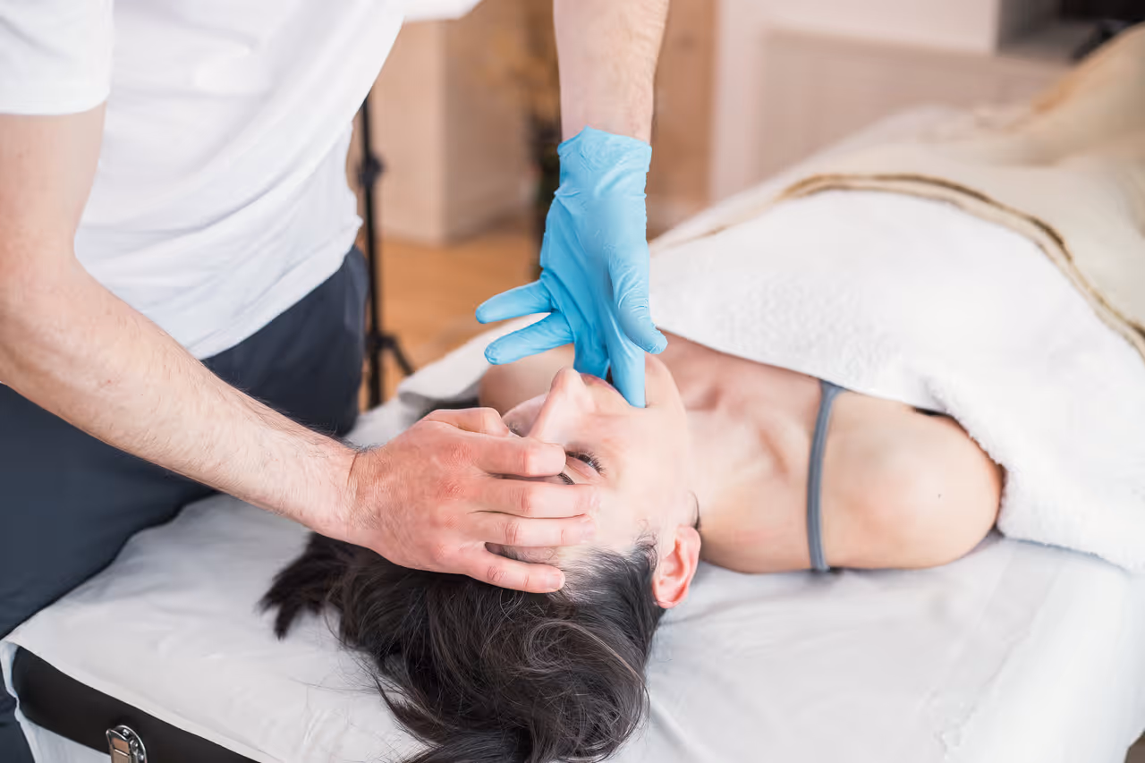 A patient relaxed in a treatment chair during a TMJ neuromuscular diagnostic at The Hills Dental Spa
